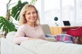 Graceful madam smiling having rest while sitting on sofa Royalty Free Stock Photo