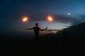 Graceful male fireshow performer making fire dance