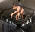 Graceful muscular sportsman workouts in the air with gymnastic rings Royalty Free Stock Photo