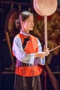 Graceful Naxi woman performs in a cultural event, Lijiang, Yunnan Province, China