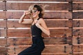 Graceful short-haired woman in stylish sunglasses having fun during photoshoot. Lovely tanned girl