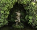 Graceful statue of women bathing in water in a cave covered with Adianthum raddianuw, venushair