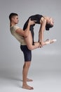 Two athletic modern ballet dancers are posing against a gray studio background. Royalty Free Stock Photo