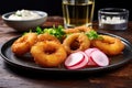gracesful onion rings on a plate with a radish salad