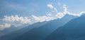 Gradations of distant mountains with blue partly cloudy sky Royalty Free Stock Photo