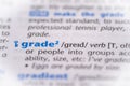 Grade word in a dictionary. Selective focus, close up Royalty Free Stock Photo