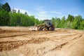 The grader clears away a ground