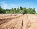 The grader clears away a ground