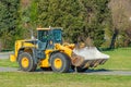 Grader and Excavator Construction Equipment on the background of trees rides on the road Royalty Free Stock Photo