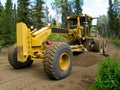 Grader resurfacing narrow rural road