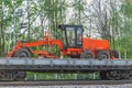 Grader stands on the railway transporter. Royalty Free Stock Photo
