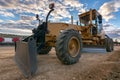 Grader working on gravel leveling