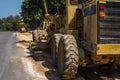 Grader is working on road construction. Grader industrial machine on construction of new roads. Heavy duty machinery Royalty Free Stock Photo