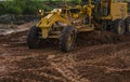 Grader is working on road construction. Grader industrial machine on construction of new roads. Heavy duty machinery Royalty Free Stock Photo