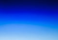 A gradient background blending from dark to light blue, creating a smooth transition from top to Royalty Free Stock Photo