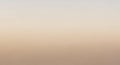 A gradient background blending soft beige and light gray tones. The smooth transition from one Royalty Free Stock Photo