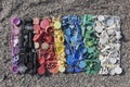 Gradient color of plastic parts, degraded still life of plastic caps and different plastic pieces found on the beach, aerial view