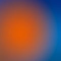 A gradient image blending vibrant orange in the center transitioning smoothly into blue Royalty Free Stock Photo