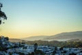 Gradient orange moutain sunset hills in the distance with shadow neighborhood in the downtown districts of San Francisco Royalty Free Stock Photo