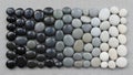 Gradient of smooth pebbles transitioning from black on the left to Royalty Free Stock Photo