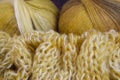 Gradient yarn ball with knitted cardigan and needles. Lemon coloured alpaca and wool threads with beautiful knitting pattern. Royalty Free Stock Photo