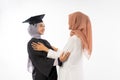 Graduate female student wearing toga chatting when meeting her friend