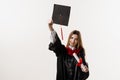 Graduate girl is graduating high school and celebrating academic achievement. Masters degree diploma in hands. Happy Royalty Free Stock Photo