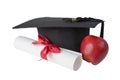 Graduate hat, red; apple and paper scroll Royalty Free Stock Photo