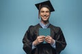 Graduate man with holding blue diploma