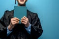 Graduate man with holding blue diploma