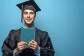 Graduate man with holding blue diploma