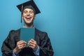 Graduate man with holding blue diploma