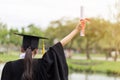 Graduate put her hands up and celebrating with certificate Royalty Free Stock Photo