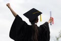 Graduate put her hands up and celebrating with certificate Royalty Free Stock Photo