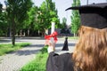 Graduate put her hands up and celebrating with certificate in her hand and feeling so happiness in Commencement day Royalty Free Stock Photo