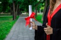 Graduate put her hands up and celebrating with certificate in her hand and feeling so happiness in Commencement day Royalty Free Stock Photo