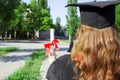 Graduate put her hands up and celebrating with certificate in her hand and feeling so happiness in Commencement day Royalty Free Stock Photo