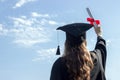 Graduate put her hands up and celebrating with certificate in her hand and feeling so happiness in Commencement day. Toned Royalty Free Stock Photo