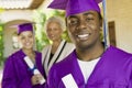 Graduate Student With Family In Background On Convocation Day Royalty Free Stock Photo