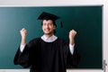 The graduate student in front of green board Royalty Free Stock Photo