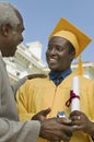 Graduate Student Receiving Gift From Father Royalty Free Stock Photo