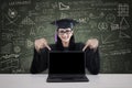 Graduate student showing copyspace on laptop Royalty Free Stock Photo