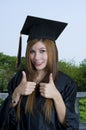 Graduate student with thumbs up sign Royalty Free Stock Photo