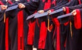 Graduate Students hold hats in hands in university graduation success ceremony. Congratulation on Education Success, Graduation