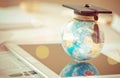 Graduate study abroad concept, Graduation cap on top Earth globe model map on laptop with Radar background. Graduate study abroad Royalty Free Stock Photo