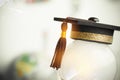 Graduate study or Education knowledge is power concept: Graduated cap Put on white light bulb and graph background. Conceptual for