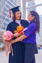 She is  Graduate and wearing  graduate`s dress.They are hug and celebration education graduation. Royalty Free Stock Photo