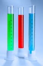 Graduated cylinders with different liquids on light background Royalty Free Stock Photo