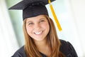She graduated with flying colours. Head and shoulders portrait of a pretty college student in her graduation gown. Royalty Free Stock Photo