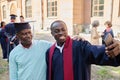 Graduated student making selfie portrait with dad Royalty Free Stock Photo